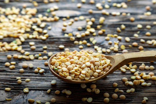 istock Dry yellow peas in spoon 1154776733