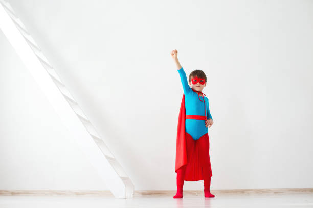 istock Boy dreamer in costume and pose superhero. 1154777980