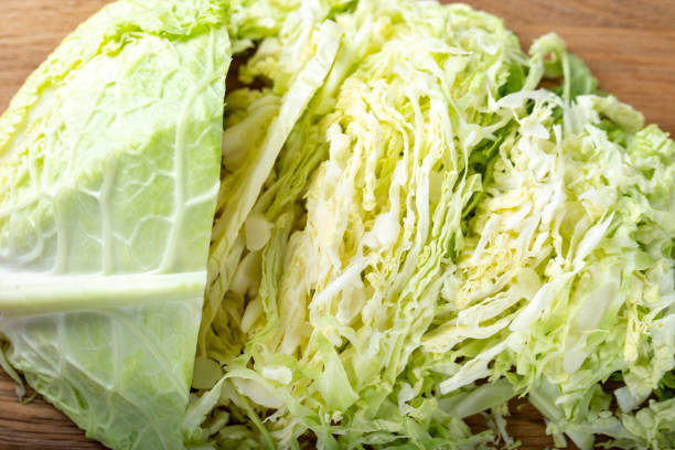 istock Chopped savoy cabbage on a wooden board. 1154778040