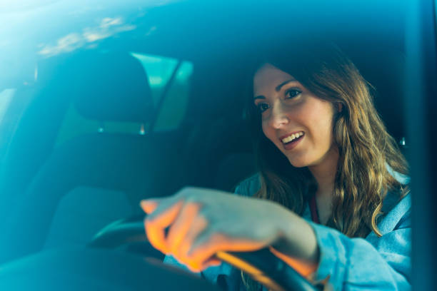 istock Young woman driving a car 1154780824