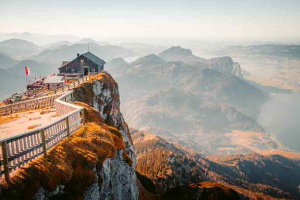 Schafberg mountain summit view at sunset, Austria Beautiful mountain scenery in the Alps with alpine mountain hut on Schafberg summit in golden evening light at sunset attersee stock pictures, royalty-free photos & images