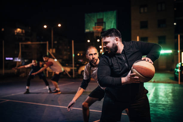 istock Male friend playing basketball 1154784258