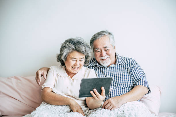 Elderly Couple Using tablet computer stock photo