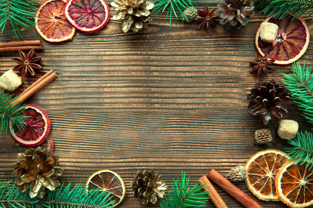 istock Christmas frame, space for text, dried oranges, cones and brown sugar. 1154784505