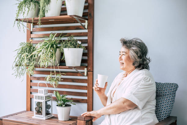 istock Senior woman sitting and drinking coffee or milk 1154785791