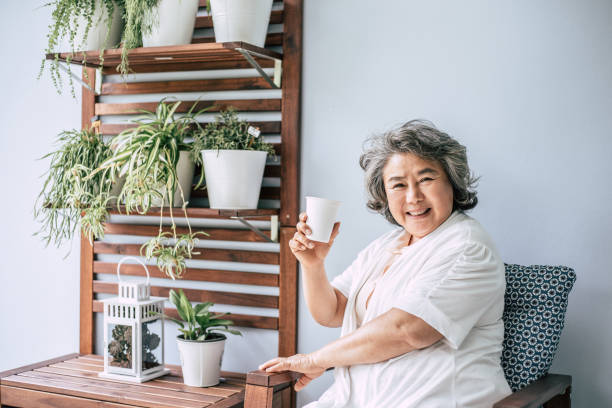 istock Senior woman sitting and drinking coffee or milk 1154785859