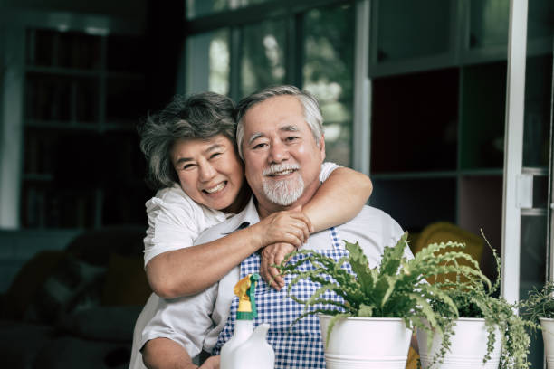 istock Elderly couples talking together and plant a trees in pots. 1154786914