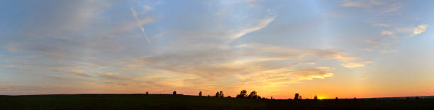 istock Panoramic view of a magnificent summer sunset and clouds in a clean field. 1154788481