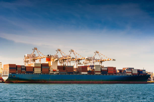 istock Transportation and Shipping Logistics Loading Dock Terminal., Container Import and Export of Sea Freight Transport Industrial., Landscape of Port Maritime and Harbor Cargo Shipyard With Crane Bridge 1154791400