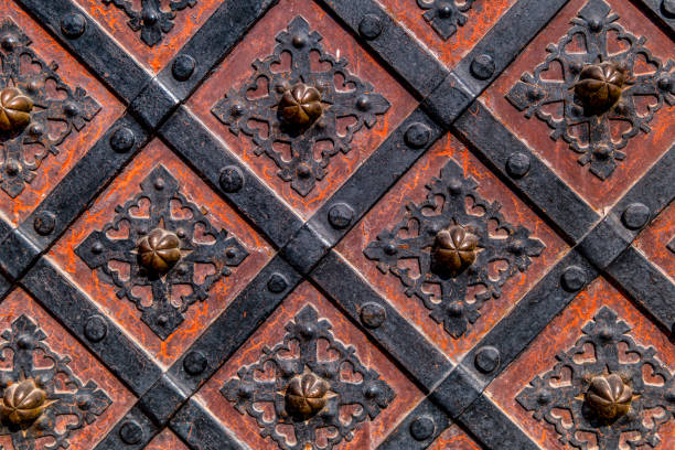 istock Ancient  gate with metal mounting and ironworks.  Beautiful decorative metal elements forged wrought iron gates. 1154791669