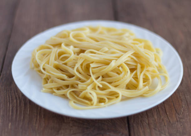 istock pasta, plate of cooked spaghetti on wooden background 1154794032