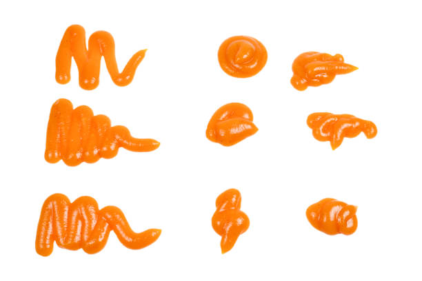 istock Orange sauce splashes isolated on white background 1154794404