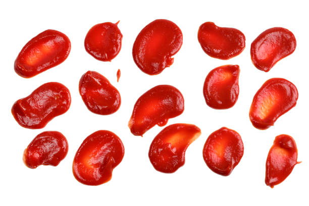 istock Red sauce splashes isolated on white background. Ketchup. 1154794409