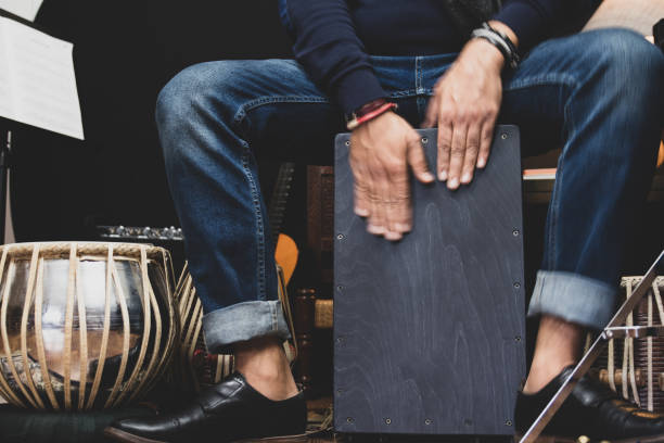A musician playing Cajon drums.