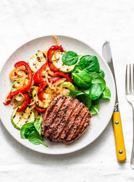 istock Grilled beef cutlet and vegetables - delicious healthy balanced lunch on a light background, top view 1154795245