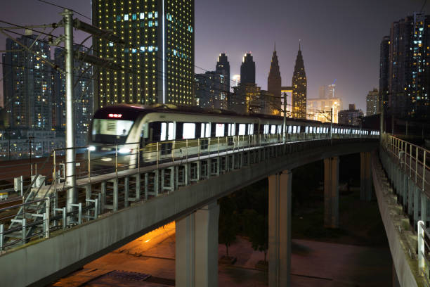 istock At night, the light rail train shuttles through the city 1154796953