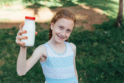 Girl Holding Milk Bottle