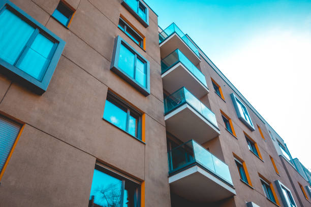 istock brown apartment house with glass balcony 1154798030