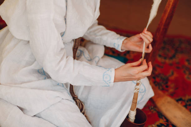 istock Woman makes thread, yarn and fabric 1154799726
