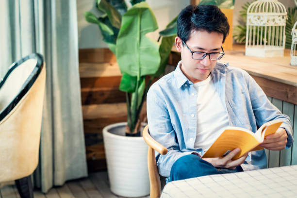istock Man Reading the book in coffee shop 1154801083