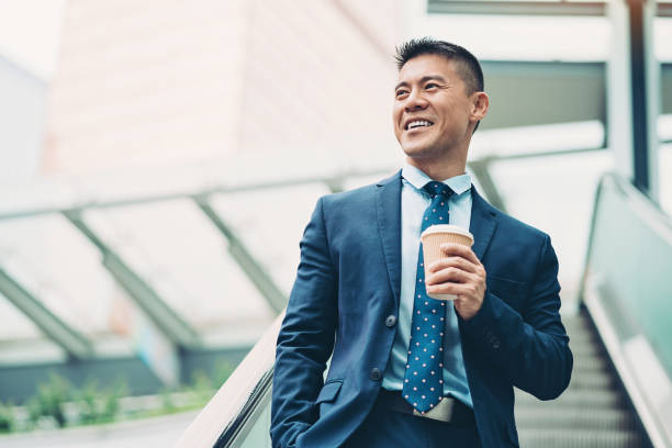 istock Smiling businessman walking by office building 1154801230