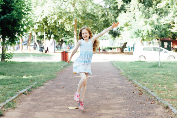 istock Beautiful Child Running in Public Park 1154803489