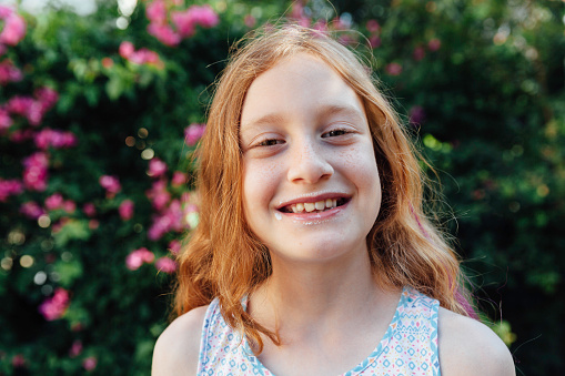 The teenage girl in white shirt on a wall background