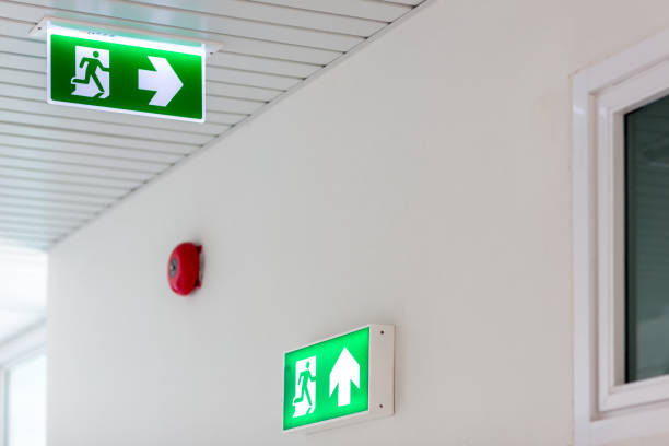 istock Green emergency exit sign showing the way to escape.Fire exit in the building. 1154805298