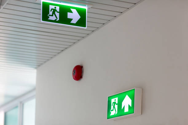 istock Green emergency exit sign showing the way to escape.Fire exit in the building. 1154805299