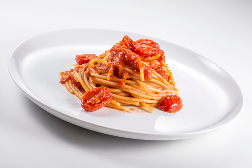 Dish of spaghetti with tomato sauce isolated on white background