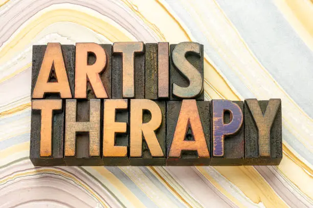 art is therapy word abstract in vintage letterpress wood type printing blocks against marbled paper