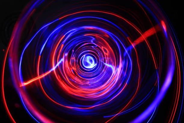 istock LED violet and blue light spinning in the dark. 1154808540