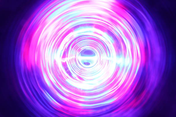istock LED violet and blue light spinning in the dark. 1154808677