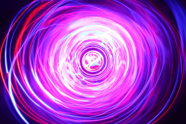 istock LED violet and blue light spinning in the dark. 1154808678