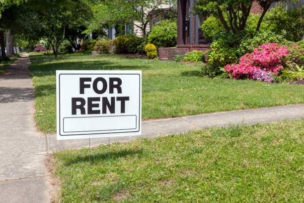 FOR RENT Sign FOR RENT sign posted in lawn advertising home for rent. yard sign stock pictures, royalty-free photos & images