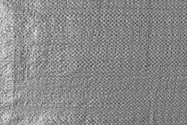Texture of the surface of the weaving of a durable garbage bag for trash. Gray color. stock photo