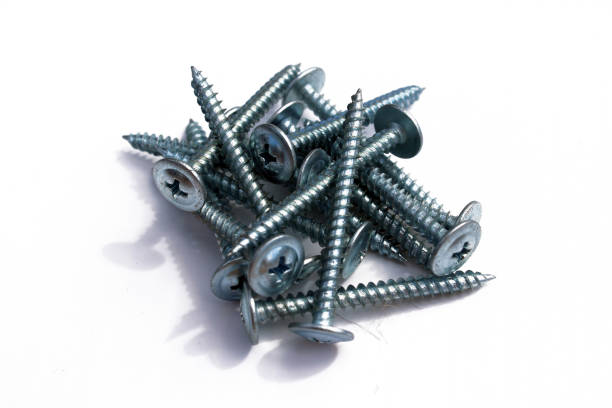 istock Long construction self-tapping screws for wood close-up on a white background. 1154813311