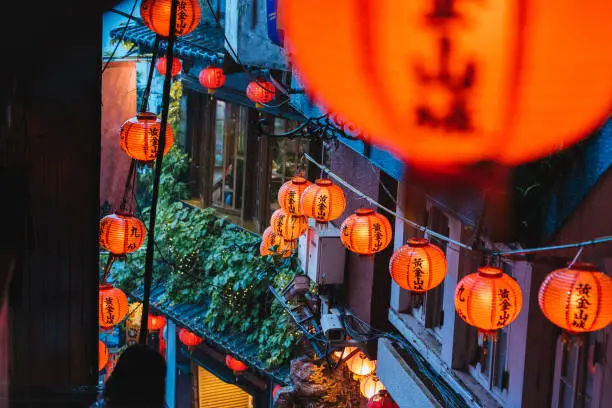 Image of Beautiful red orange lanterns on the Old Street in Jiufen, Taiwan. Chinese Text "Gold Mining Town"