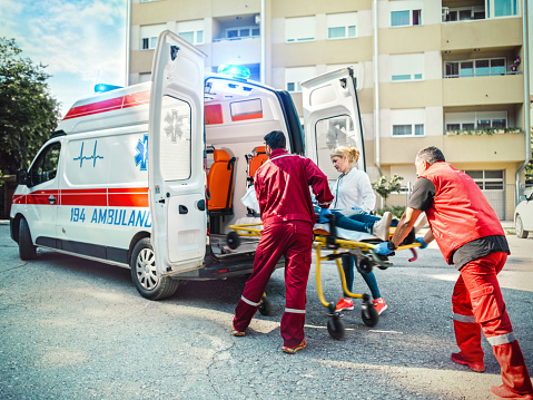Medical emergency team helping injured woman