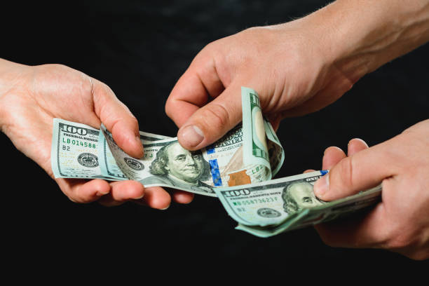 istock Payment of services, receiving bribes, exchange for information, Dollar bills. 1154818004