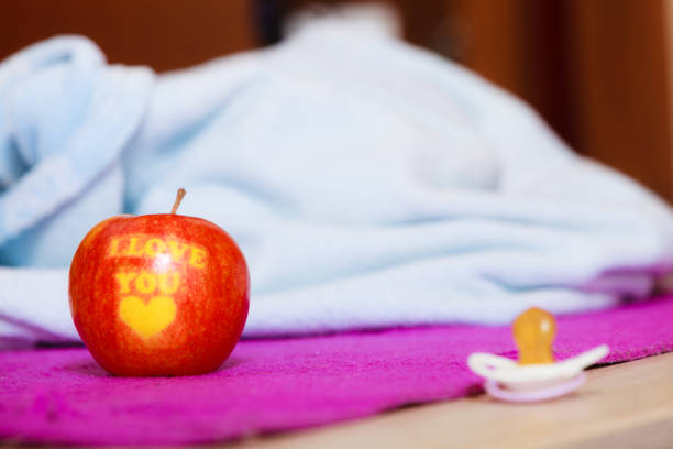 Baby is holding an green apple