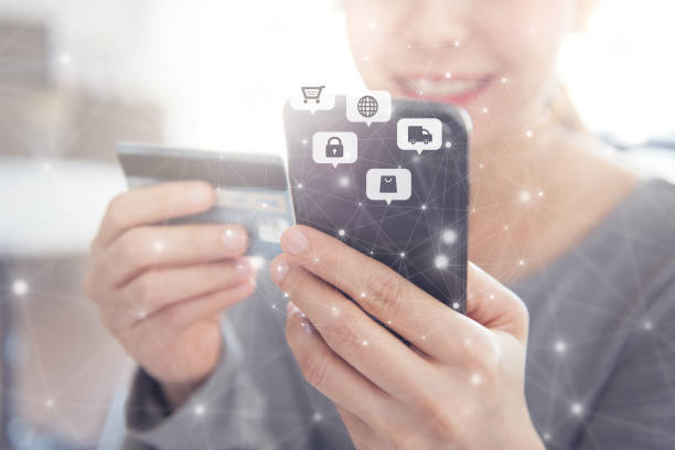 istock Close up hands holding credit card and using mobile smart phone with icon Online shopping, E-Commerce. 1154821644