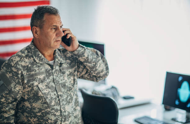 istock Serious senior soldier talking on smart phone 1154821815