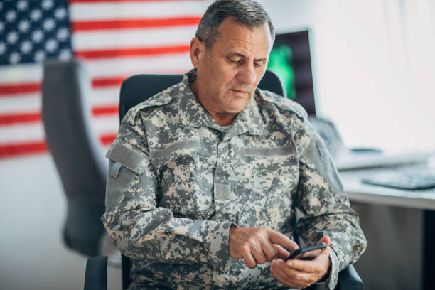 istock Senior soldier using smart phone at the office 1154822687