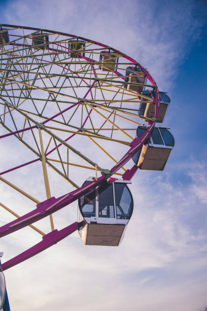 Cabins Ferris wheel on the background of clouds