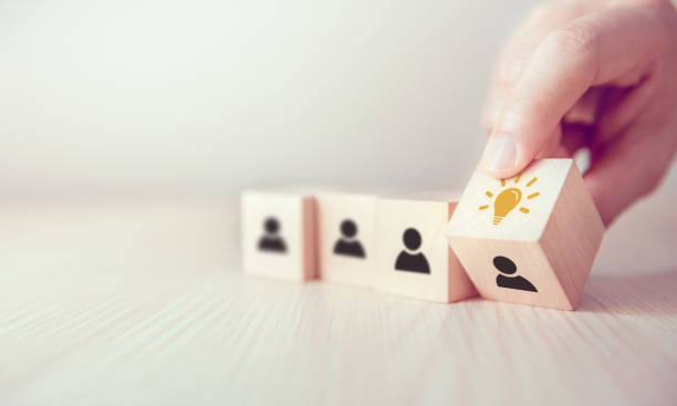 istock Leader with idea and innovation, Woman hand flips cube with icon light bulb and human symbol. 1154826797