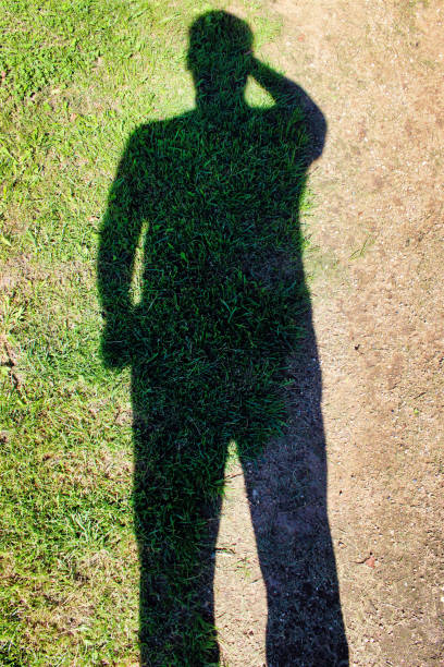 istock Shadow grass of a man in the sand. 1154826842