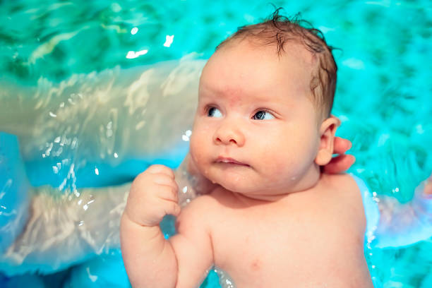 Baby boy swimming in pool