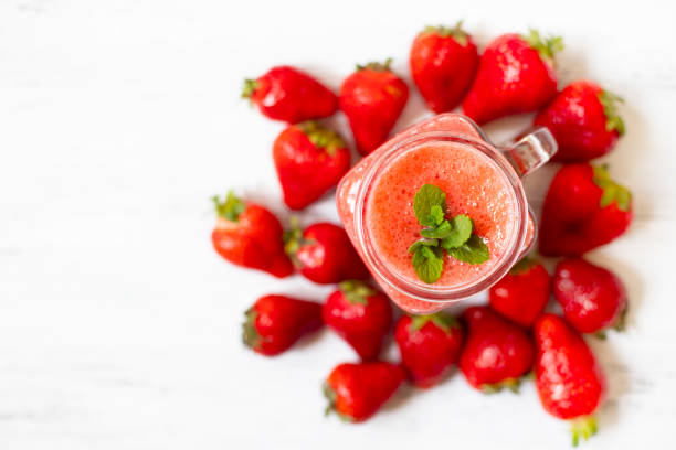 istock Strawberry smoothies or strawberries with ice in a jar. A refreshing summer drink. White background. Top view. Copy space 1154830224