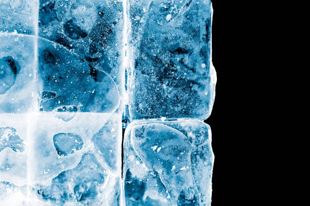 istock Textured frosty crystal clear ice blocks isolated on black background. 1154830699